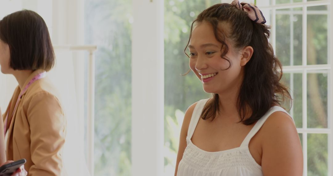 Bride and Bridesmaids Smiling While Preparing for Wedding