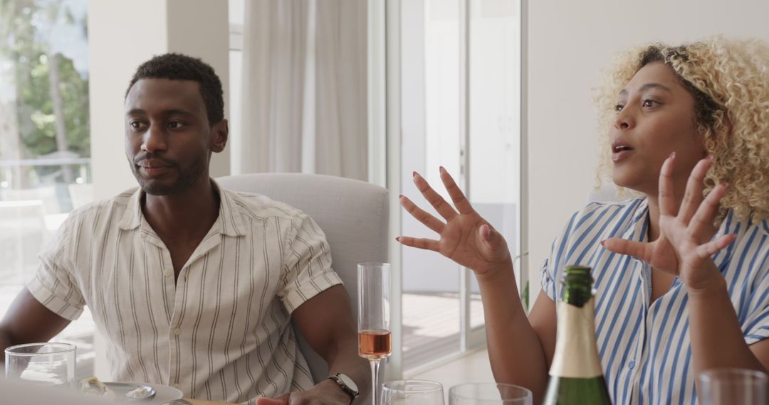 Diverse Friends Enjoying Lively Conversation Over Drinks Indoors