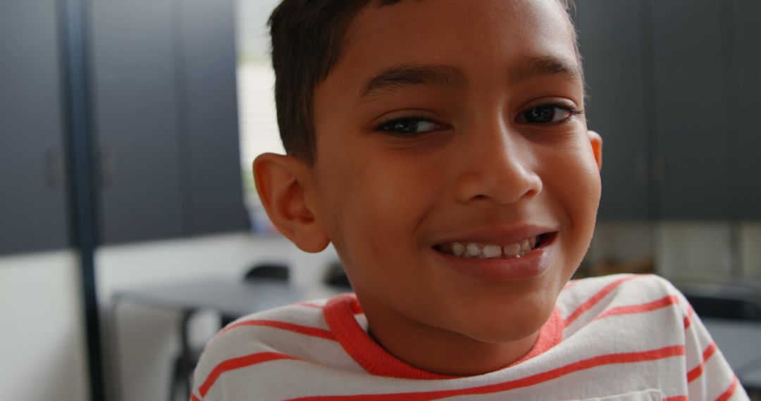 Smiling Asian Schoolboy in Classroom Close-Up