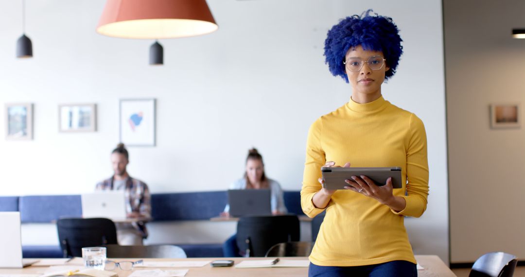 Confident Businesswoman in Modern Office Setting with Tablet