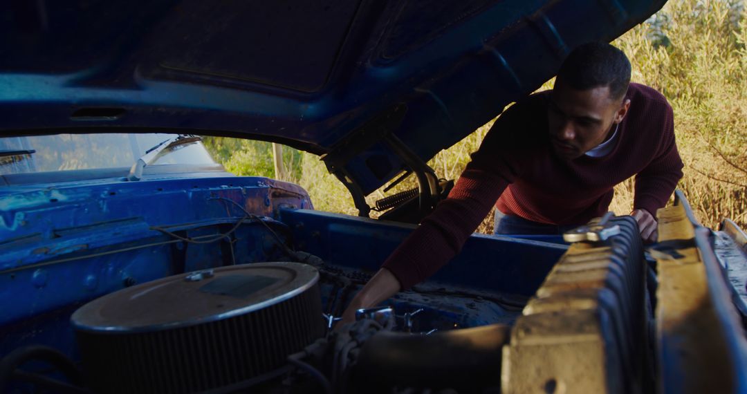 Man Inspecting Vintage Car Engine Outdoors - Free Images, Stock Photos and Pictures on Pikwizard.com