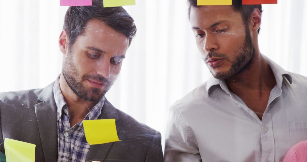 Two Professional Men Collaborating on Office Project with Sticky Notes - Free Images, Stock Photos and Pictures on Pikwizard.com