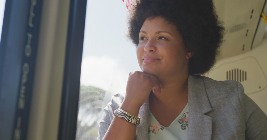 Confident Woman Enjoying Bus Ride While Deep in Thought