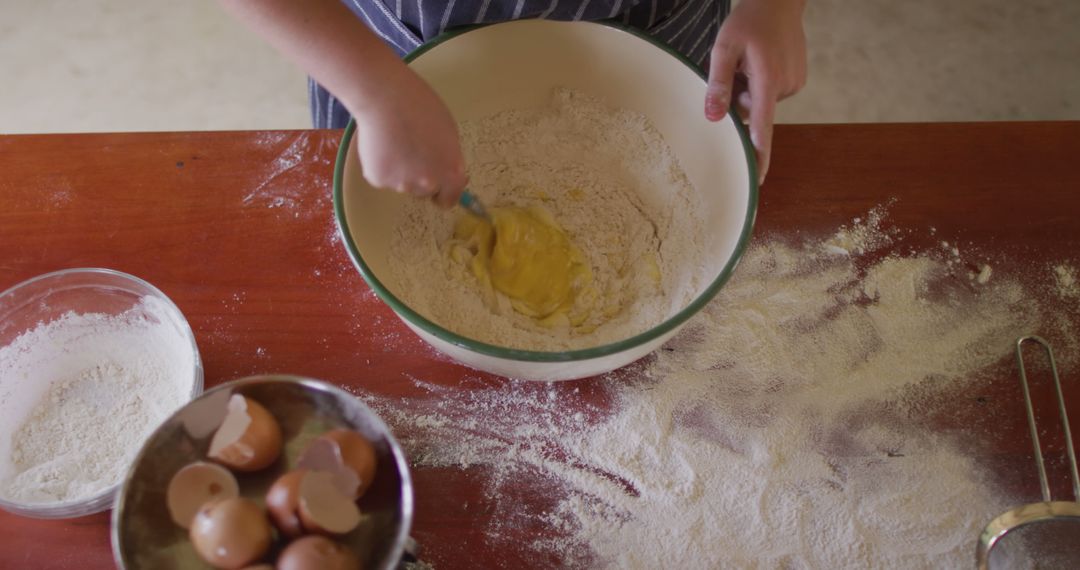 Person Baking Dough with Flour and Eggs on Wooden Table - Free Images, Stock Photos and Pictures on Pikwizard.com