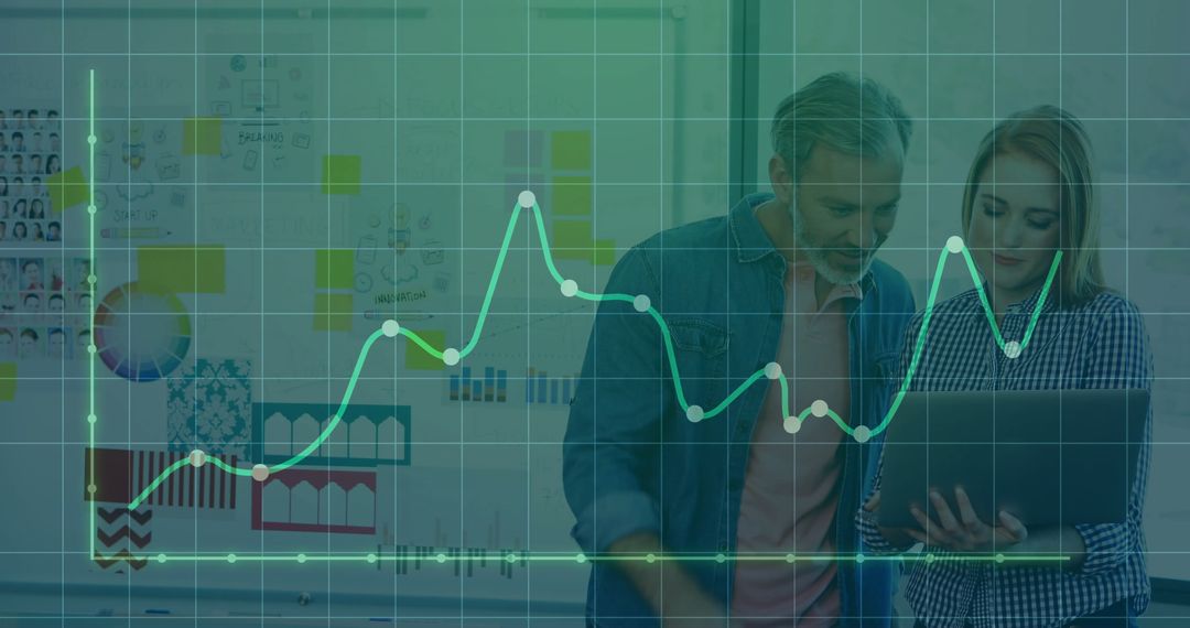Colleagues Analyzing Data with Graph Overlay in Office