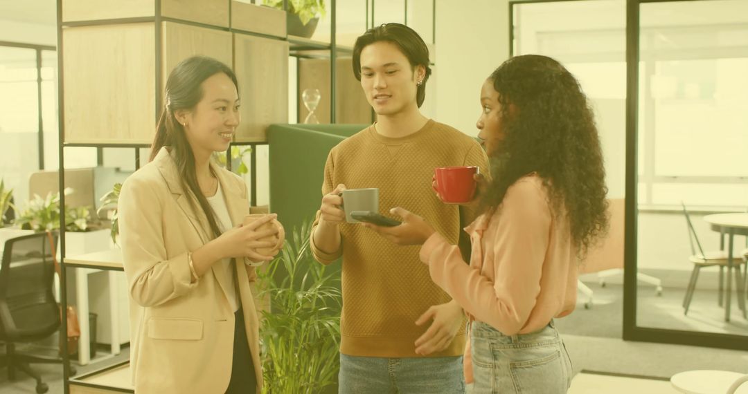 Colleagues Engaging in Coffee Break Discussion in Modern Office