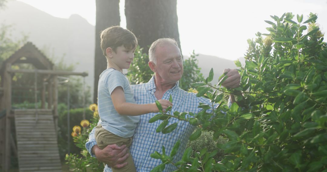 Grandfather Carrying Grandson Together in Garden - Free Images, Stock Photos and Pictures on Pikwizard.com