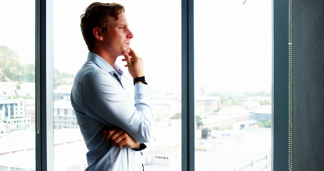 Businessman Contemplating Future While Looking Out Office Window - Free Images, Stock Photos and Pictures on Pikwizard.com