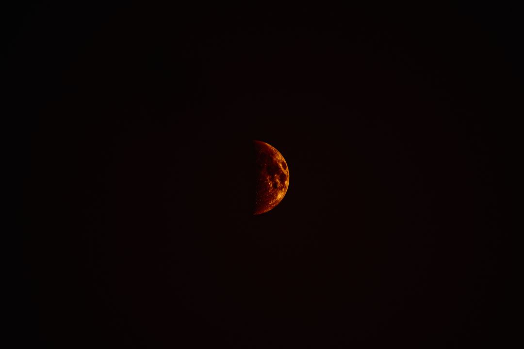 Half Red Moon in Dark Night Sky