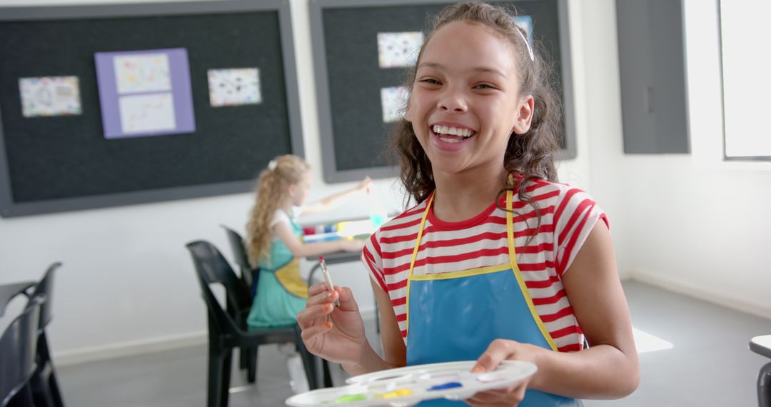 Joyful Student Creating Art in Class with Paint Palette