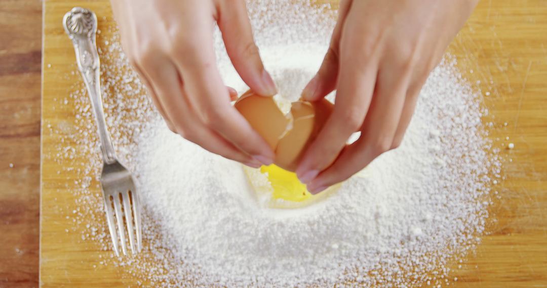 Hands Cracking Egg Into Flour On Wooden Surface - Free Images, Stock Photos and Pictures on Pikwizard.com