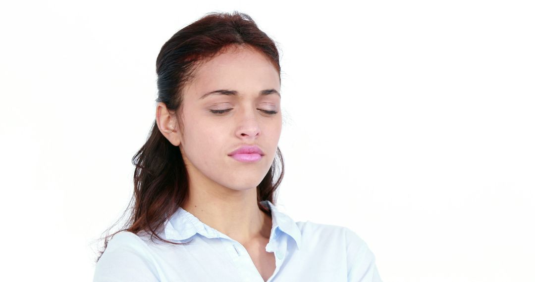 Woman Looking Serious with Eyes Closed in Light Blue Shirt - Free Images, Stock Photos and Pictures on Pikwizard.com