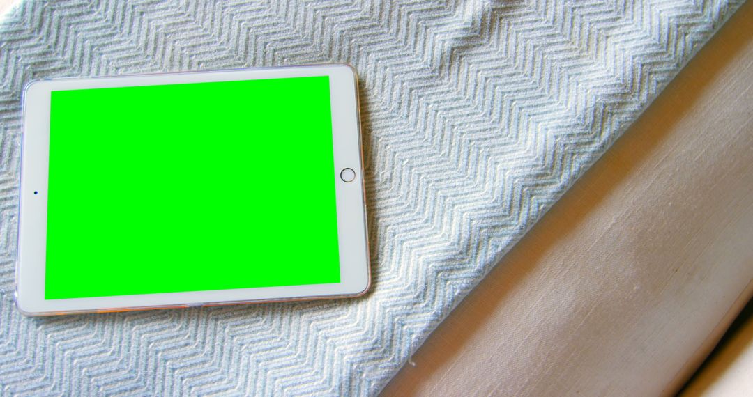 Tablet on Herringbone Tablecloth Displaying Green Screen - Free Images, Stock Photos and Pictures on Pikwizard.com