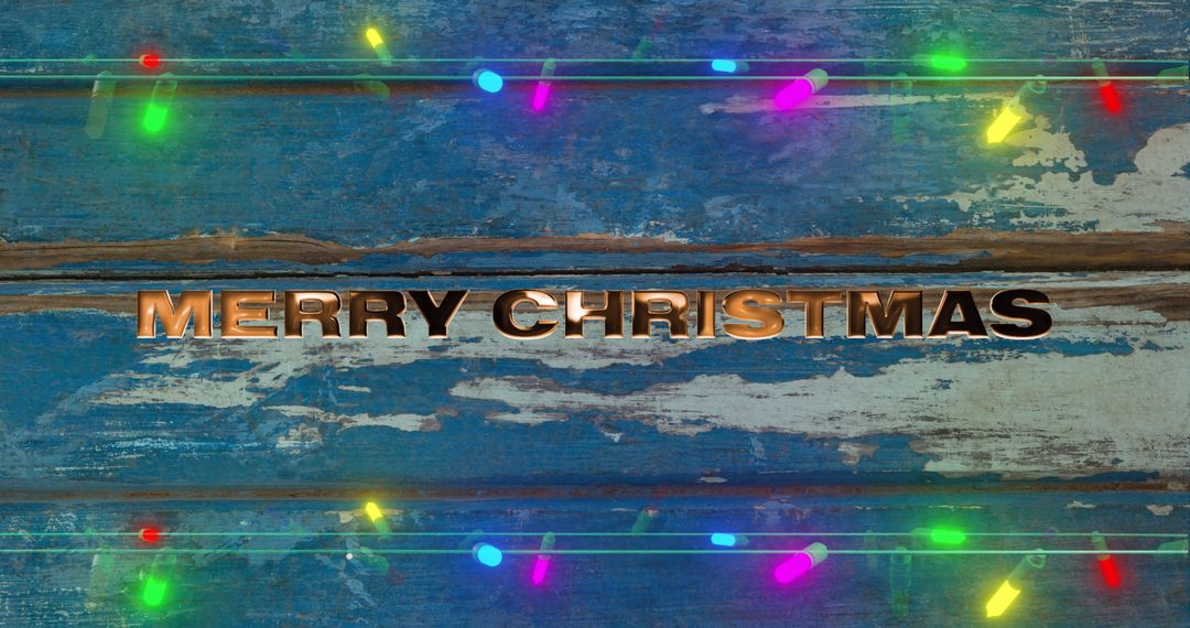 Merry Christmas Text on Rustic Blue Wooden Background with Lights