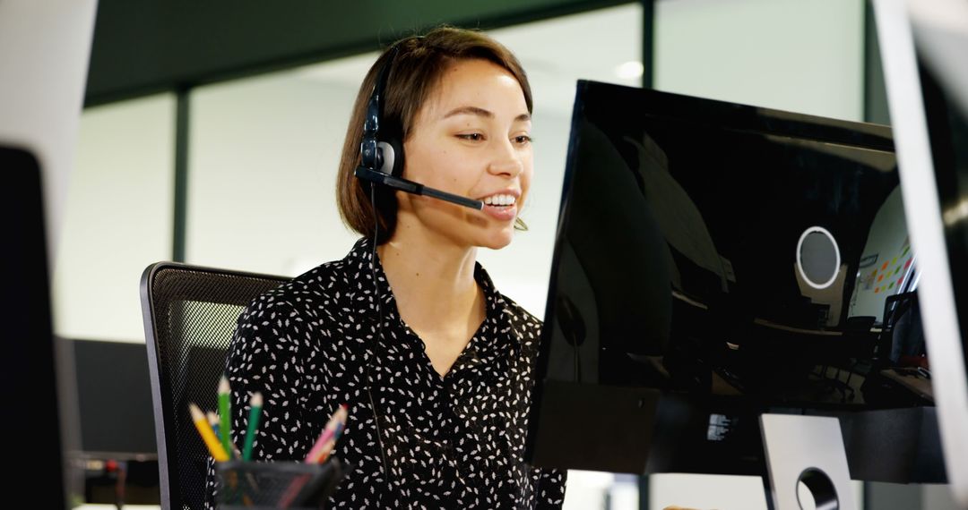 Customer Service Executive Engaging with Client via Headset in Modern Office
