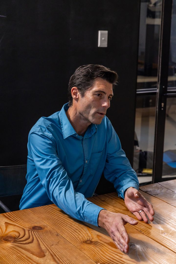Businessman Gesturing During Meeting in Modern Office