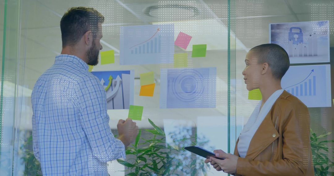 Business Professionals Collaborating by Optimal Glass Board with Diagrams