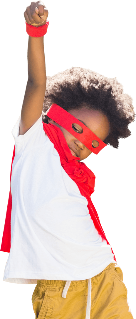 Joyful Child in Red Superhero Costume Raising Fist