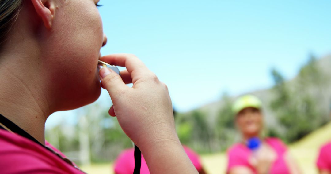 Female Sports Coach Blowing Whistle on Field with Team - Free Images, Stock Photos and Pictures on Pikwizard.com