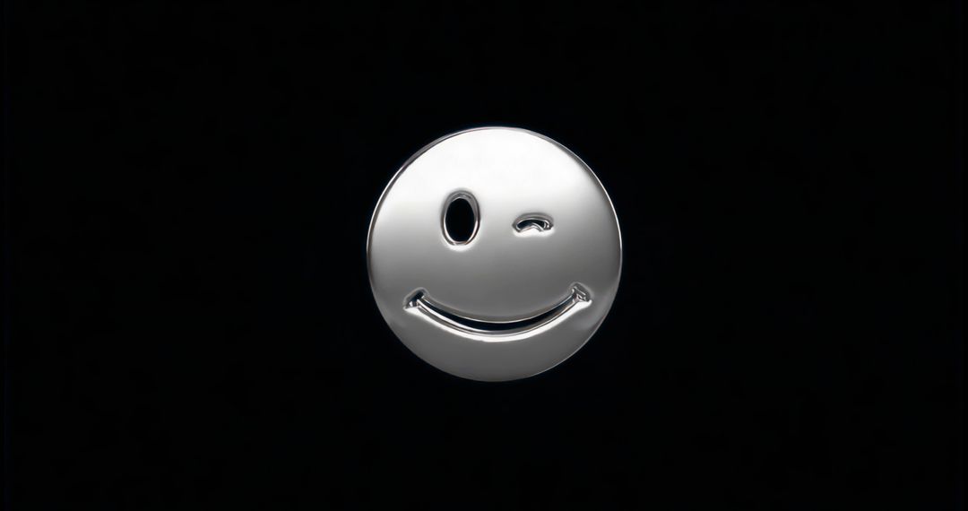 Metallic winking emoticon on black background