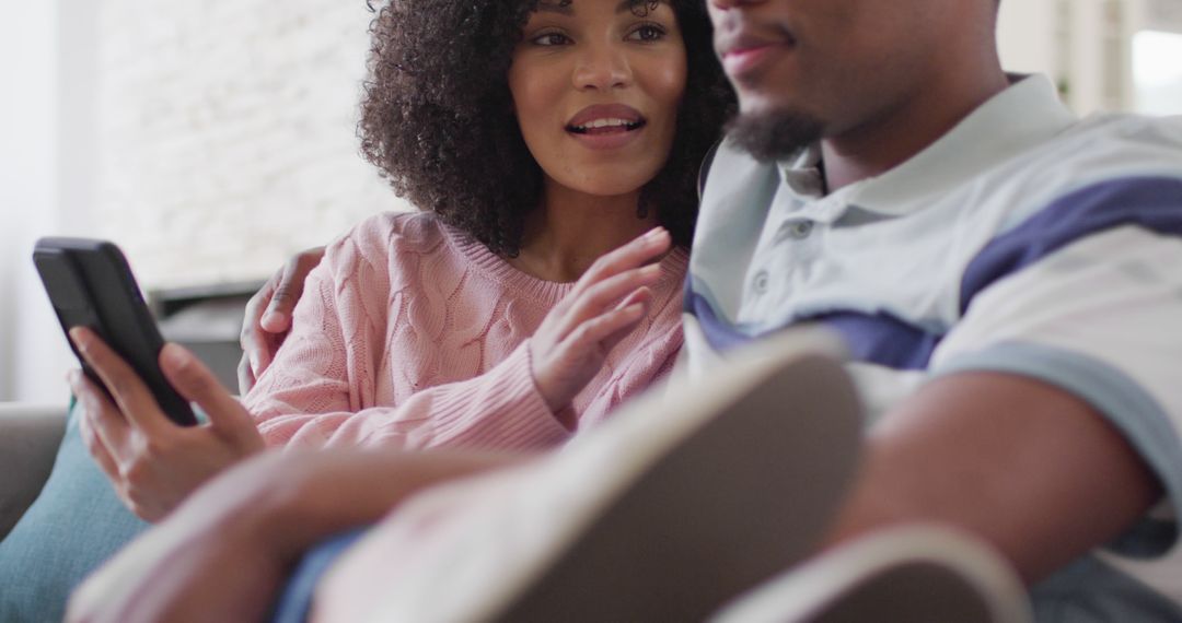 Couple Enjoying Smartphone Together at Home