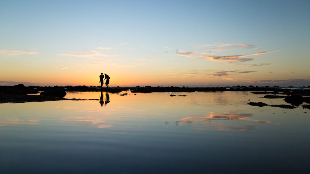 Couple Enjoying Romantic Sunset Near Calm Ocean Waters - Free Images, Stock Photos and Pictures on Pikwizard.com