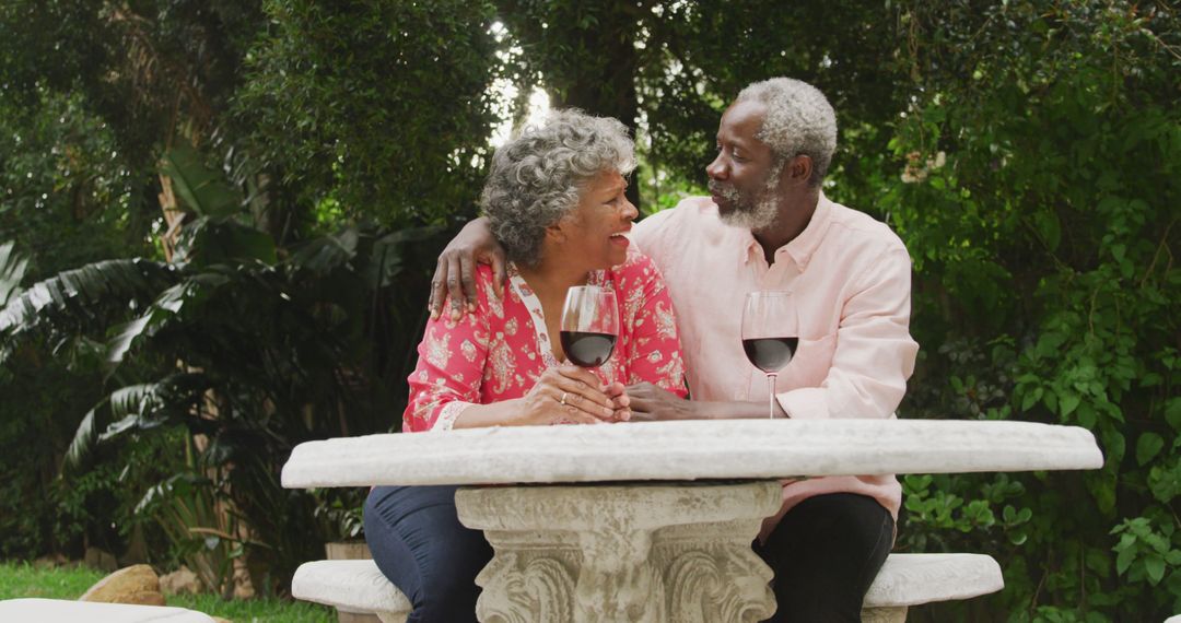 Happy elderly couple enjoying wine in garden - Free Images, Stock Photos and Pictures on Pikwizard.com