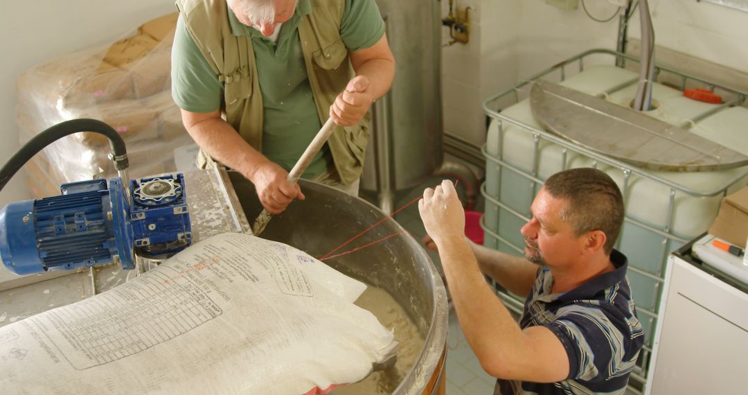 Artisanal Cheesemakers Working in Dairy, Stirring Milk Mixture - Free Images, Stock Photos and Pictures on Pikwizard.com