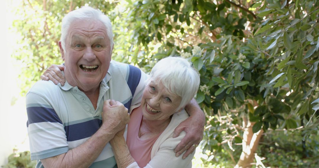 Cheerful Senior Couple Enjoying Time in Lush Garden