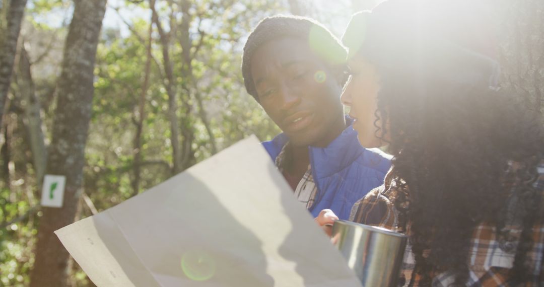 Diverse Couple Reading Map During Sunny Hike