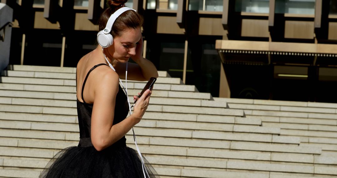 Ballet Dancer Wearing Headphones on Urban Steps - Free Images, Stock Photos and Pictures on Pikwizard.com