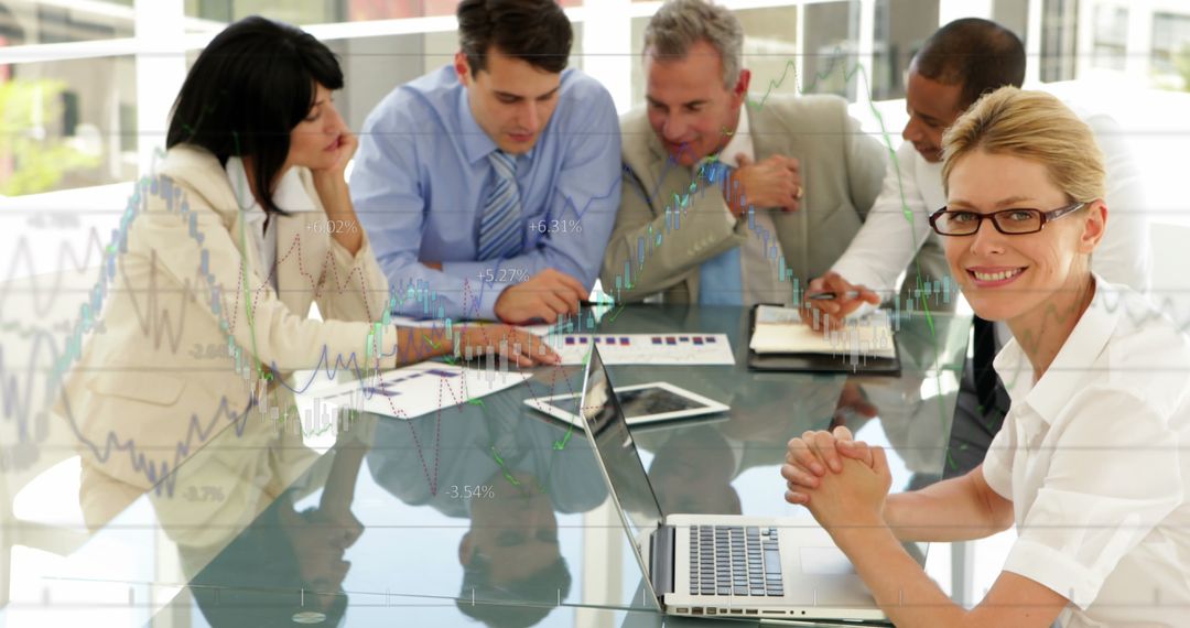 Diverse Team Collaborating on Financial Strategy with Technology