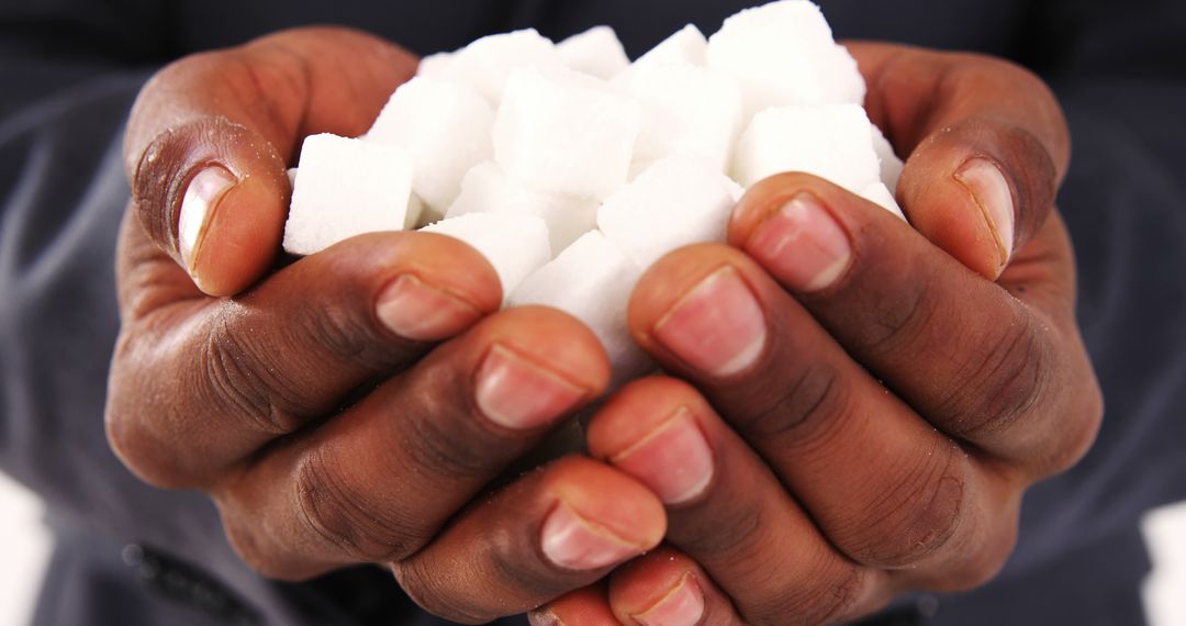African American hands are cupped together, holding a pile of sugar cubes, with copy space - Free Images, Stock Photos and Pictures on Pikwizard.com