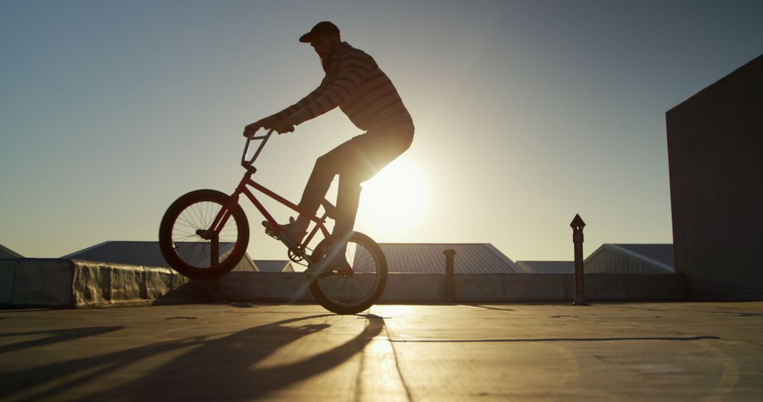 BMX Rider Performing Stunt at Sunset Against Silhouette - Free Images, Stock Photos and Pictures on Pikwizard.com