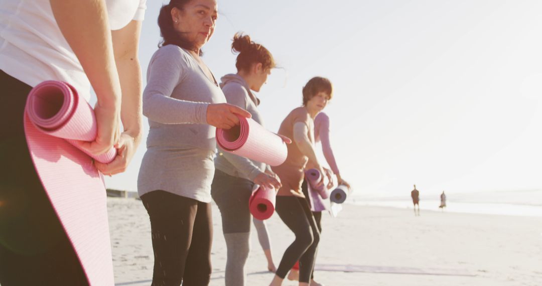 Women with Yoga Mats Preparing for Outdoor Beach Exercise - Free Images, Stock Photos and Pictures on Pikwizard.com