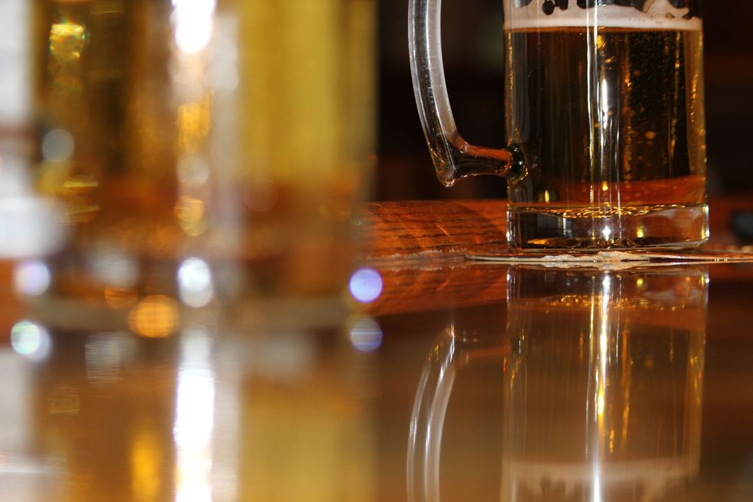 Close-up of Beer Mug on Pub Table with Reflections