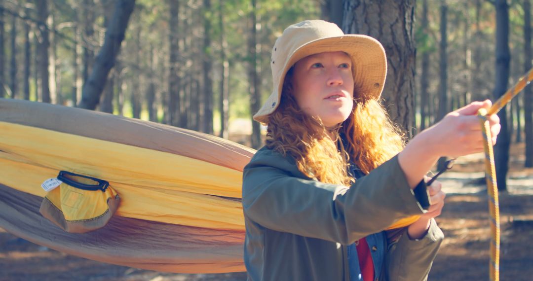 Young Woman Setting Up Hammock in Forest - Free Images, Stock Photos and Pictures on Pikwizard.com