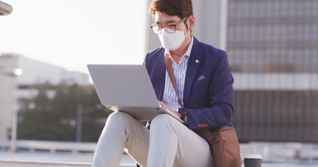 Businessman in Suit and Face Mask Working on Laptop Outdoors - Free Images, Stock Photos and Pictures on Pikwizard.com