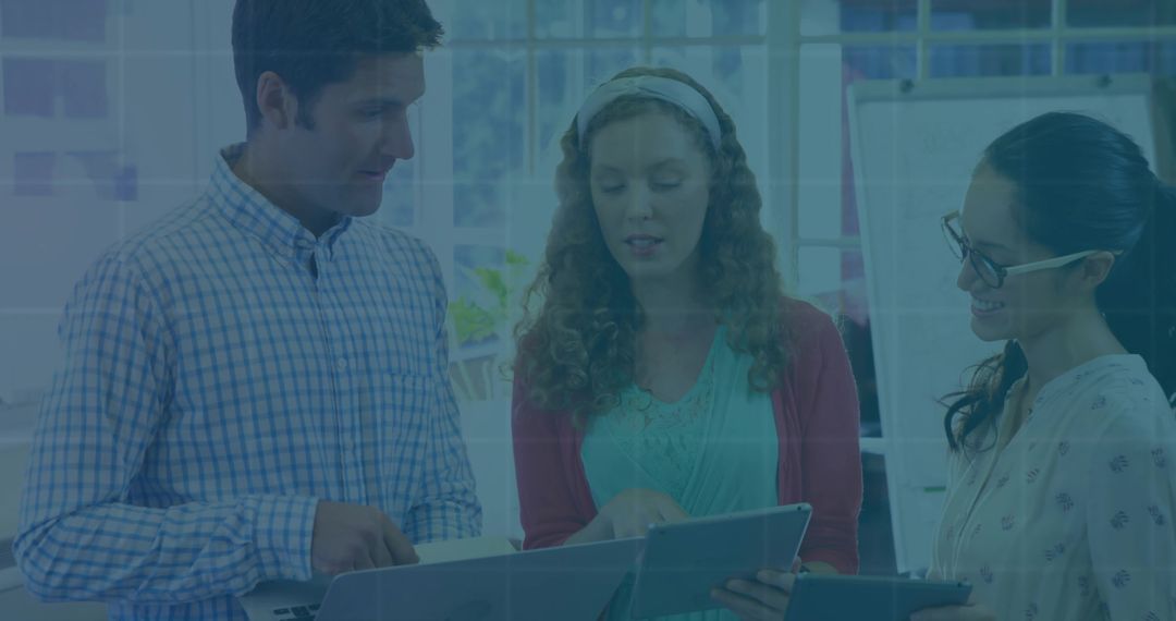 Trio Collaborating in Modern Office with Tablets
