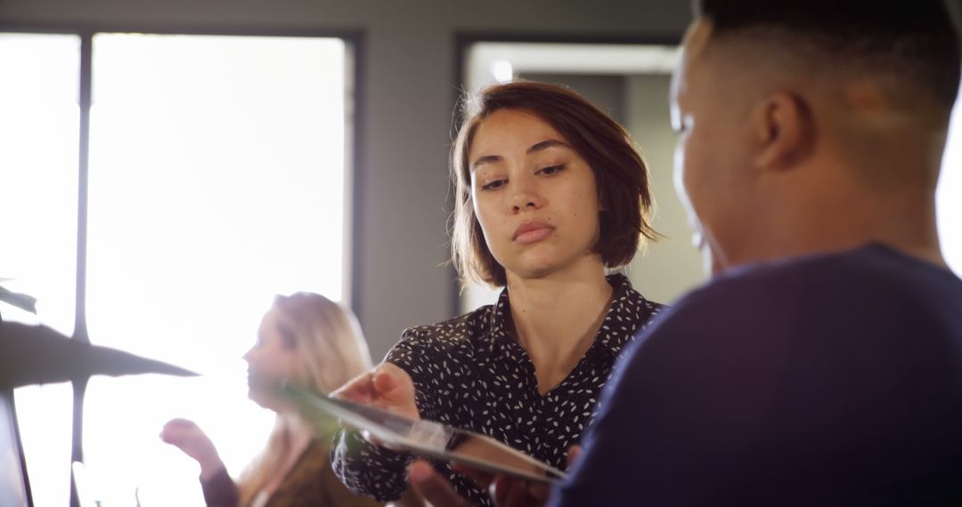 Corporate Team Collaborating with Digital Tablet in Modern Office