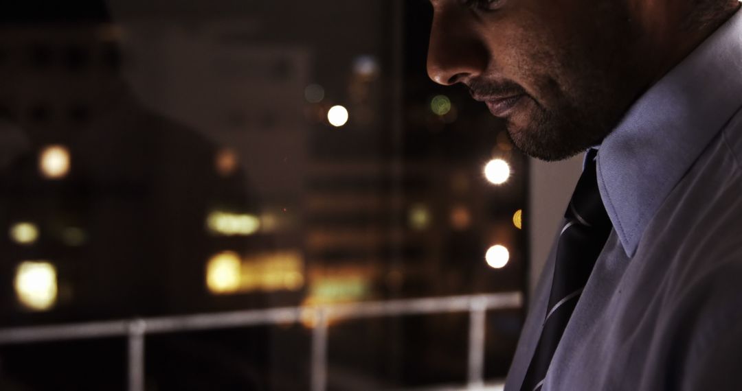 Businessman Reflecting by Office Window at Night - Free Images, Stock Photos and Pictures on Pikwizard.com