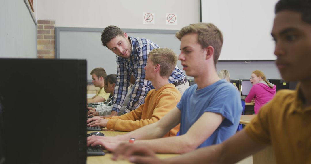 Teacher Assisting Teenage Boys in Computer Lab - Free Images, Stock Photos and Pictures on Pikwizard.com