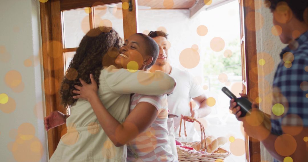 Hugging friends at sunlit doorway with picnic basket and celebratory bokeh