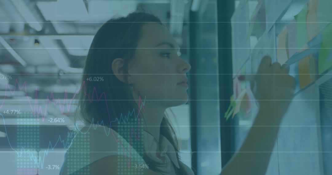 Businesswoman Planning Strategies with Data Overlay