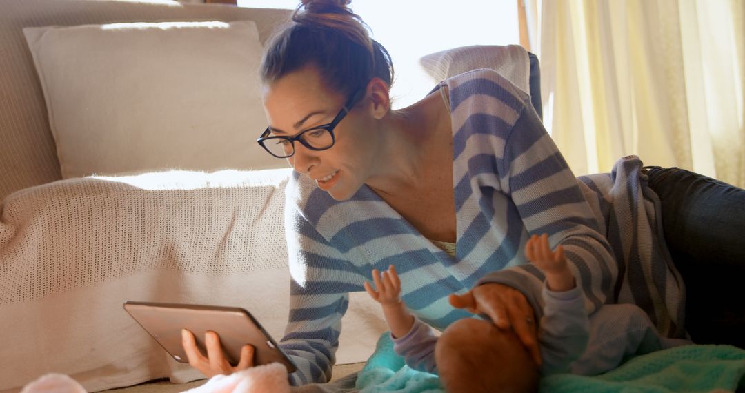 Mother Engaging with Baby on Floor Using Tablet - Free Images, Stock Photos and Pictures on Pikwizard.com