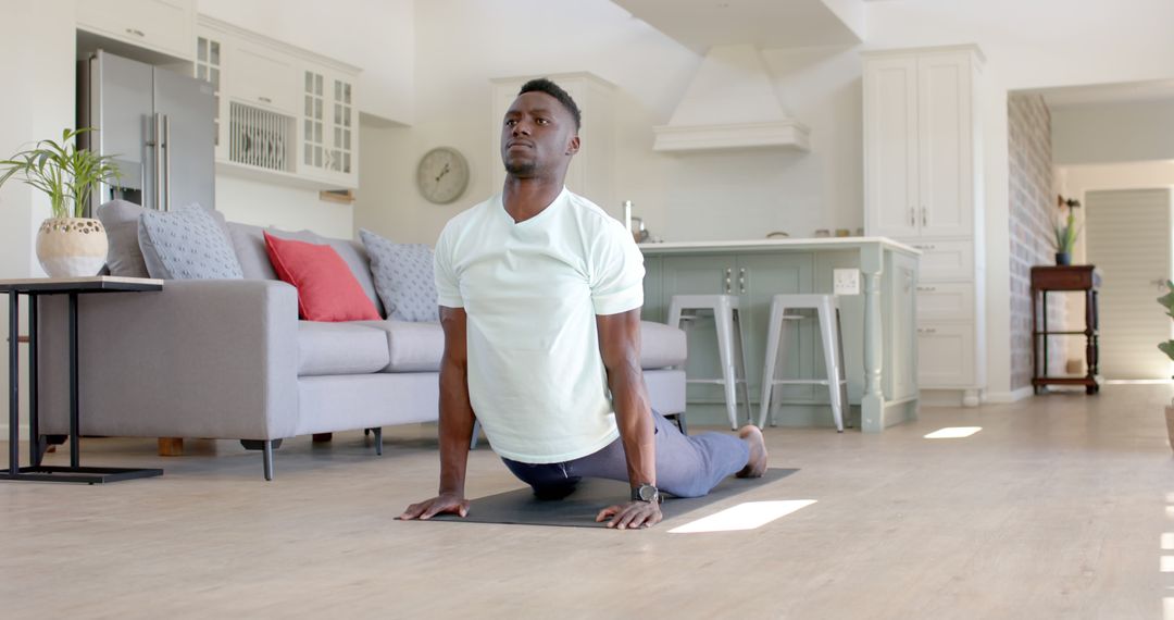 Focused Man Practicing Yoga in Bright Living Room - Free Images, Stock Photos and Pictures on Pikwizard.com