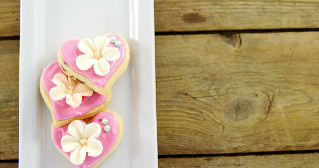 Heart-Shaped Cookies with Pink Icing and Floral Decorations on Wooden Table - Free Images, Stock Photos and Pictures on Pikwizard.com