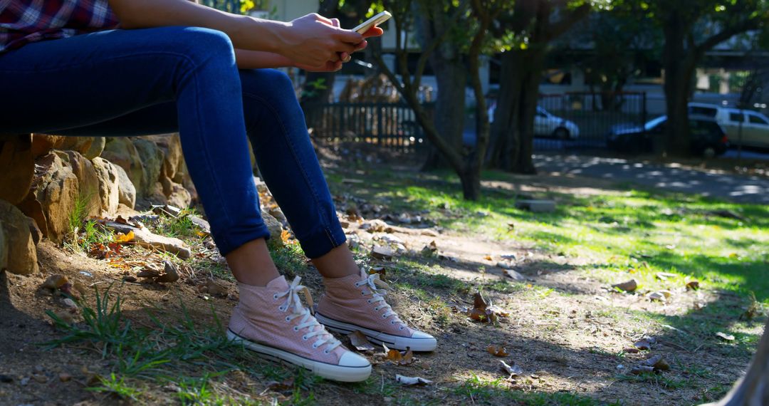 Young Adult Sitting in Park Using Smartphone - Free Images, Stock Photos and Pictures on Pikwizard.com