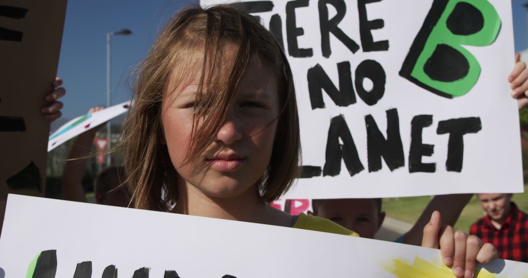 Young Activist Holding Climate Change Protest Sign - Free Images, Stock Photos and Pictures on Pikwizard.com