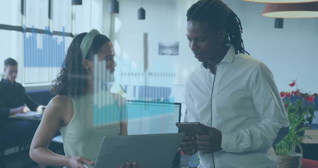 Coworkers Collaborating with Digital Devices in Modern Office